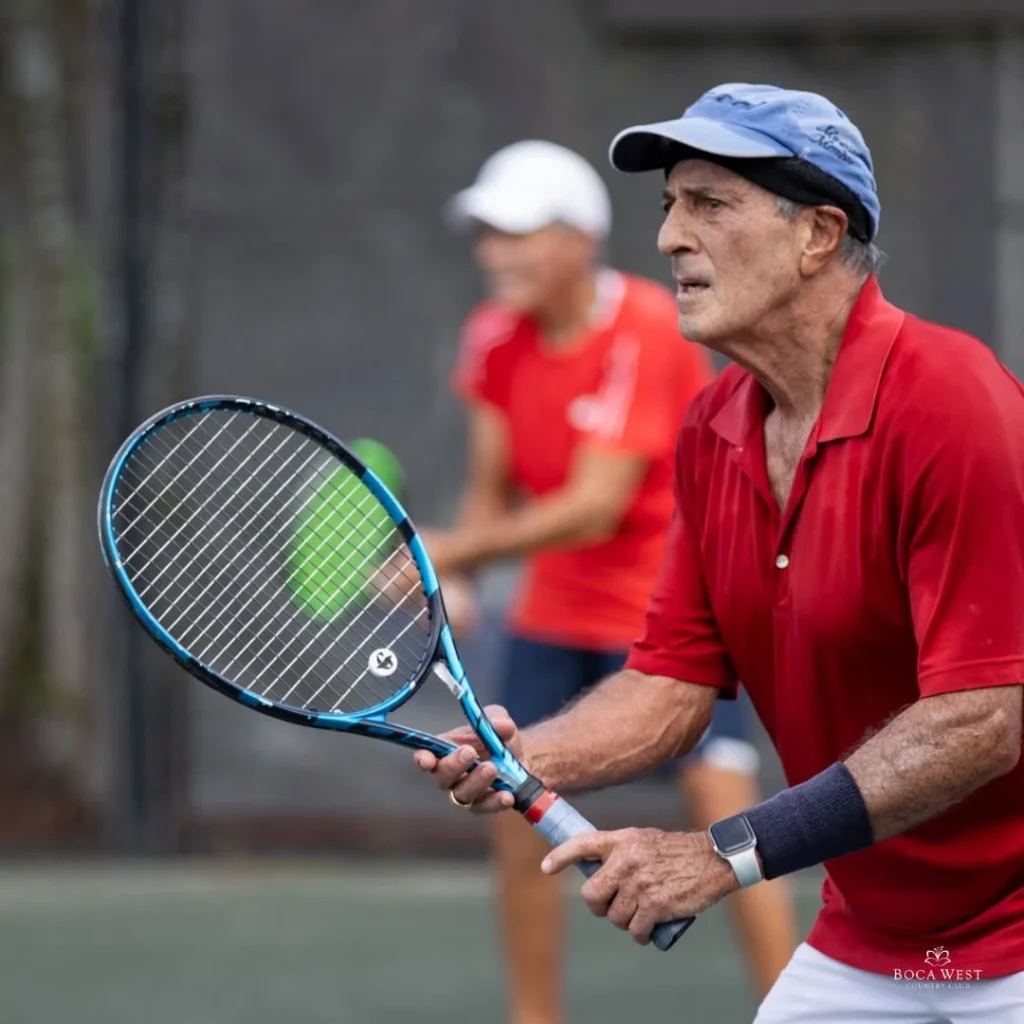 Member playing tennis at Boca West Country Club in Boca Raton Florida