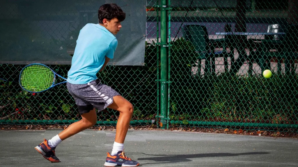 Junior tennis player practicing on a clay court at Delray Beach Tennis Center