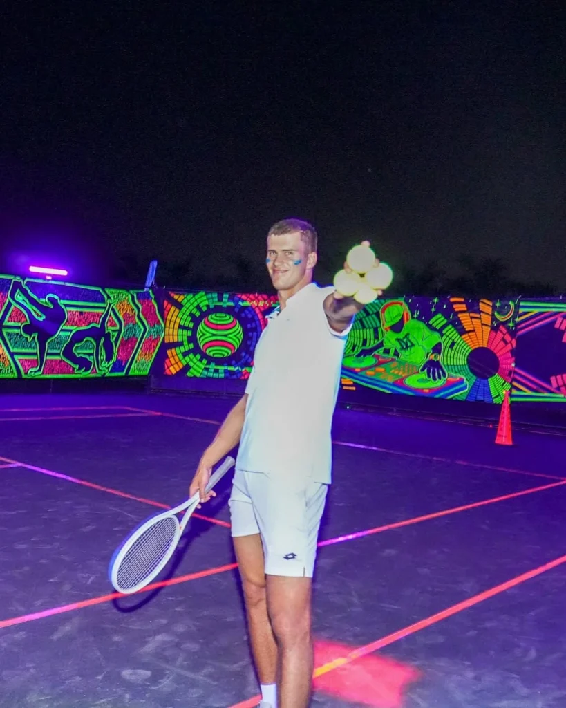 Resident participating in a glow tennis social event at Hunter’s Run Country Club in Boynton Beach