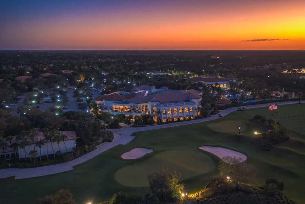 Evening aerial view of the clubhouse and golf course at The Club at Mirasol in Palm Beach Gardens Florida