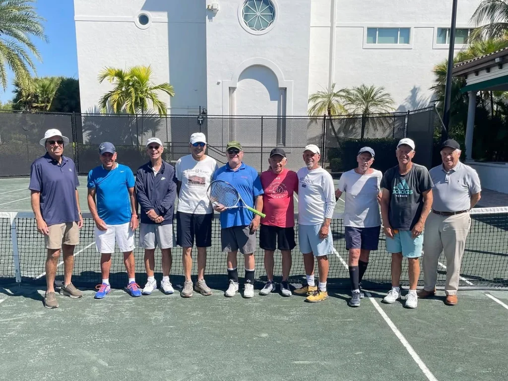 Members participating in a men’s tennis program at The Club at Mirasol in Palm Beach Gardens Florida