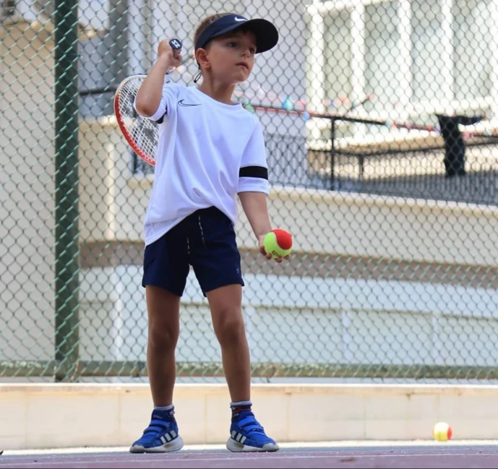 Junior tennis player participating in youth development program at Patch Reef Paddle and Racquet Club