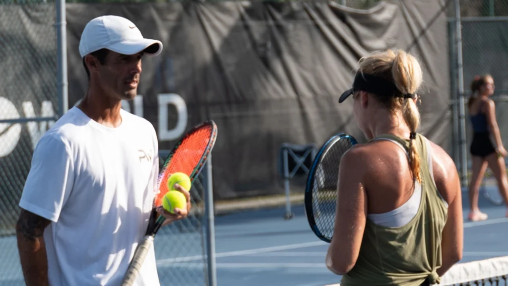 Tennis coach working with academy player at ProWorld Academy