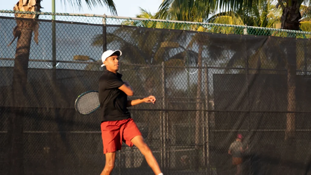 Junior player practicing on outdoor courts at ProWorld Academy