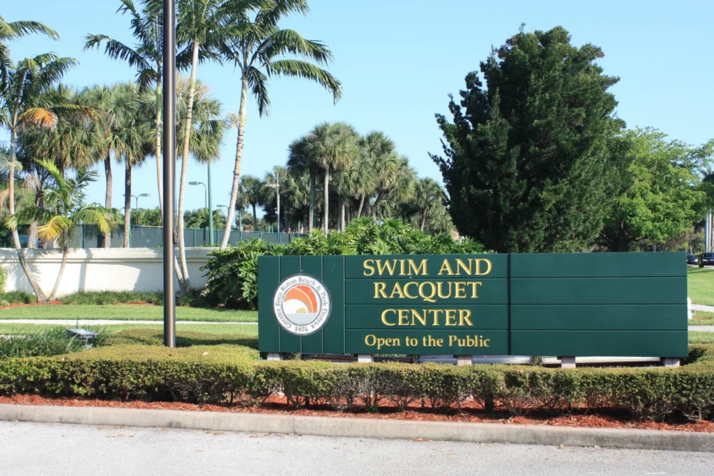 Entrance sign for The Racquet Center public tennis facility in Boca Raton Florida