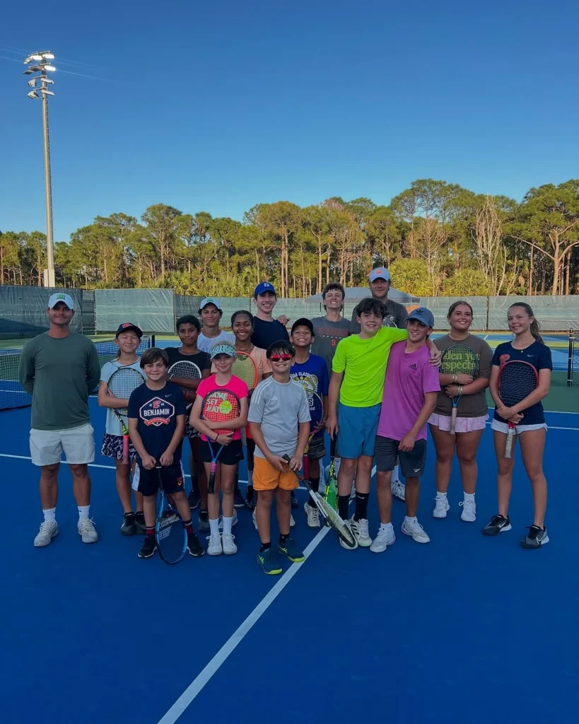 Junior players participating in an Apex Tennis Academy training session in Palm Beach Gardens