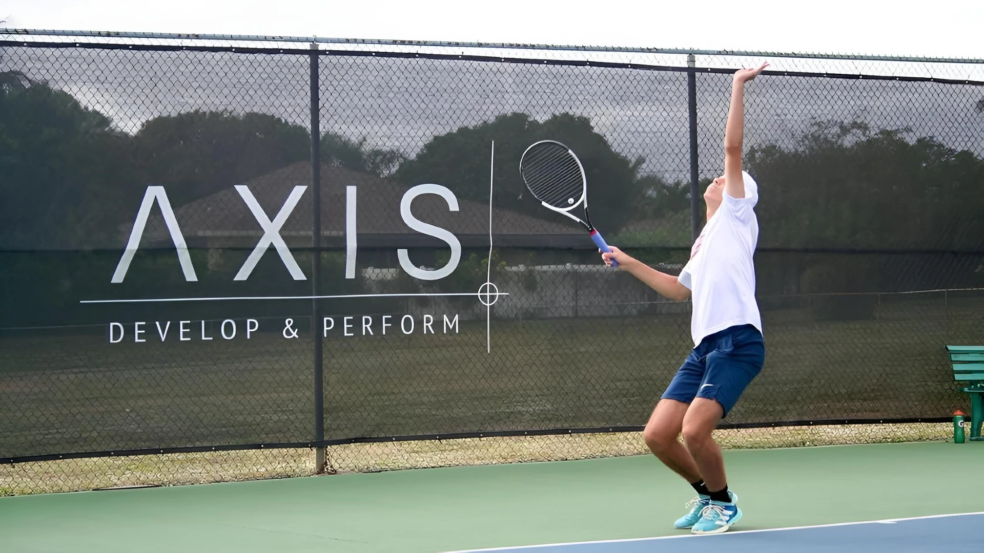 Junior player serving during training at Axis Tennis Academy in Delray Beach