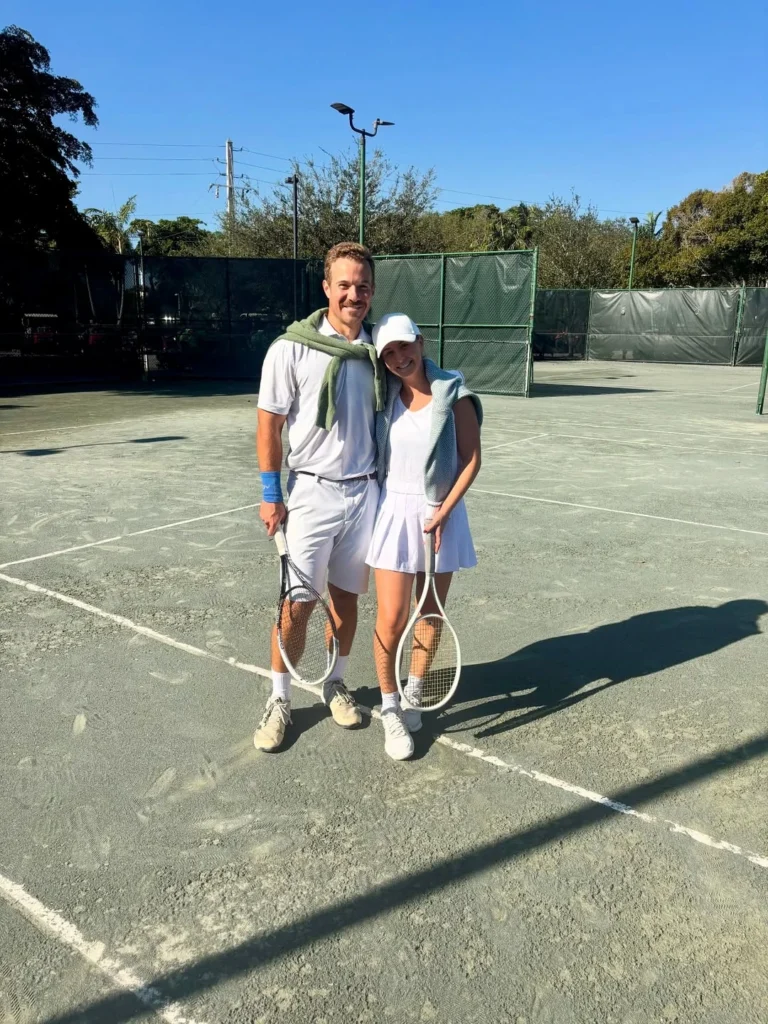 Members playing mixed doubles tennis at Bear Lakes Country Club