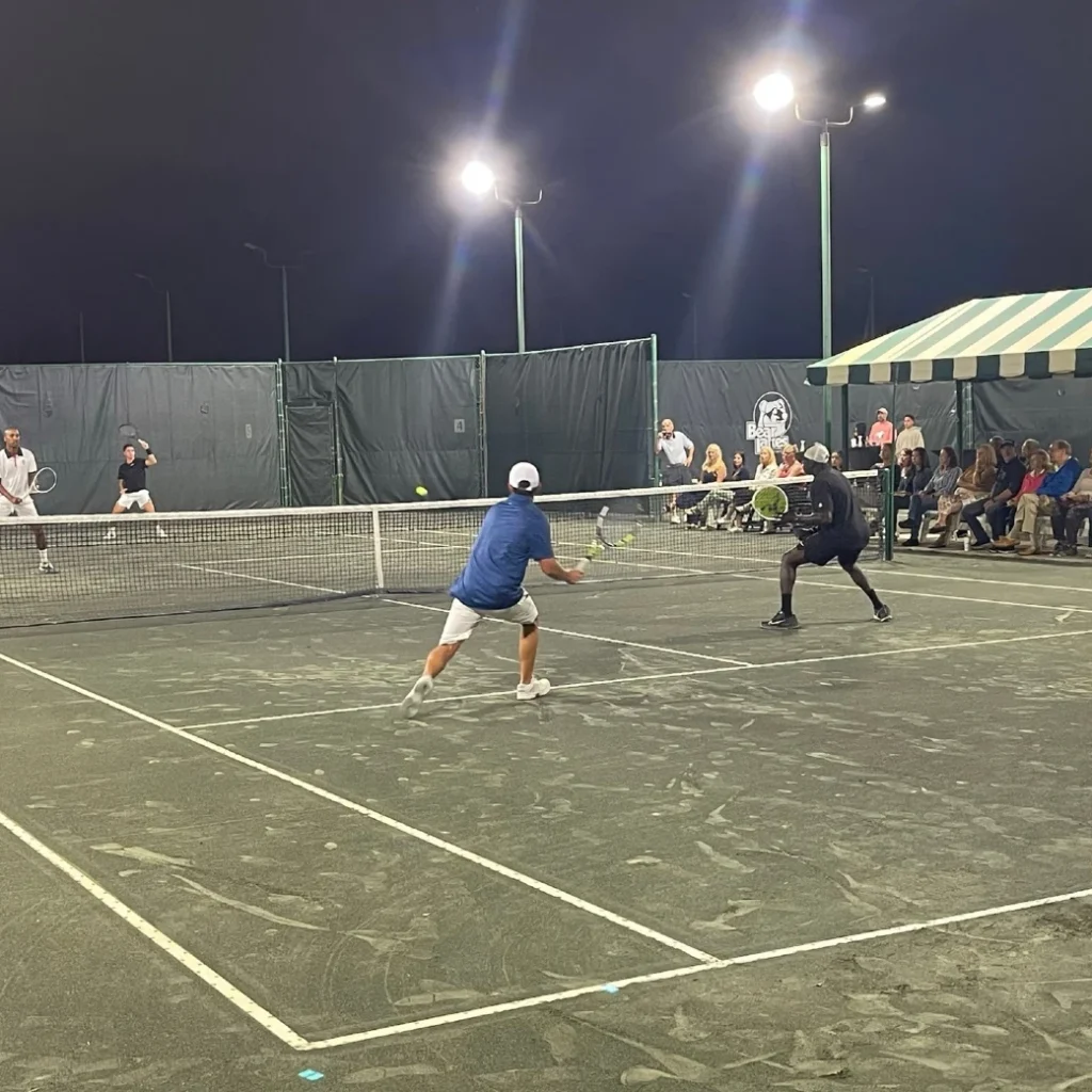 Members playing evening tennis under the lights at Bear Lakes Country Club