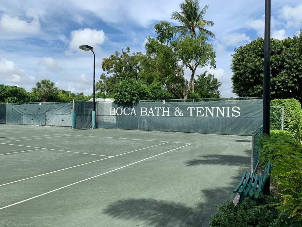 Har-Tru tennis courts with Boca Bath & Tennis windscreen signage in Boca Raton