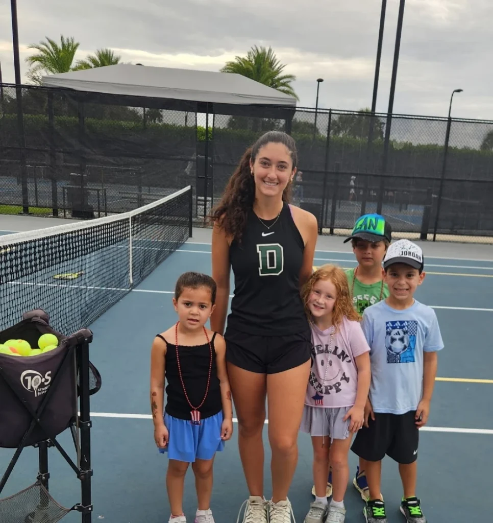 Tennis instructor with junior players at Boca Bridges racquet club in Boca Raton Florida