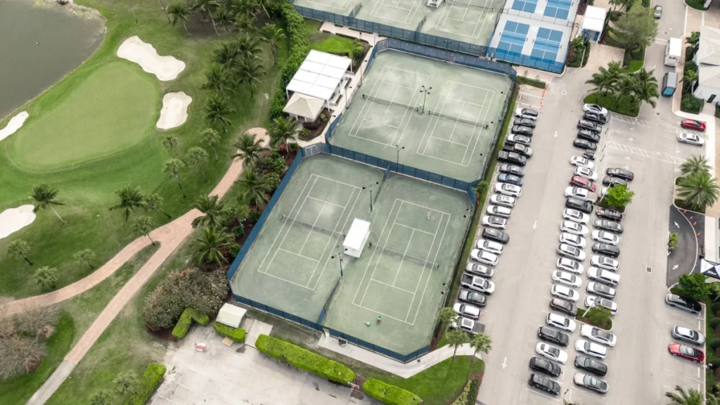 Aerial view of Boca Woods Har-Tru tennis complex beside one of the club's championship golf courses.