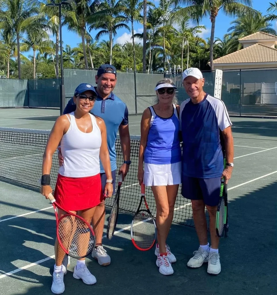 Members playing mixed doubles tennis at Bocaire Country Club in Boca Raton