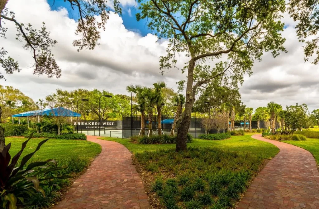 Landscaped entrance leading to the Breakers West tennis and pickleball facilities