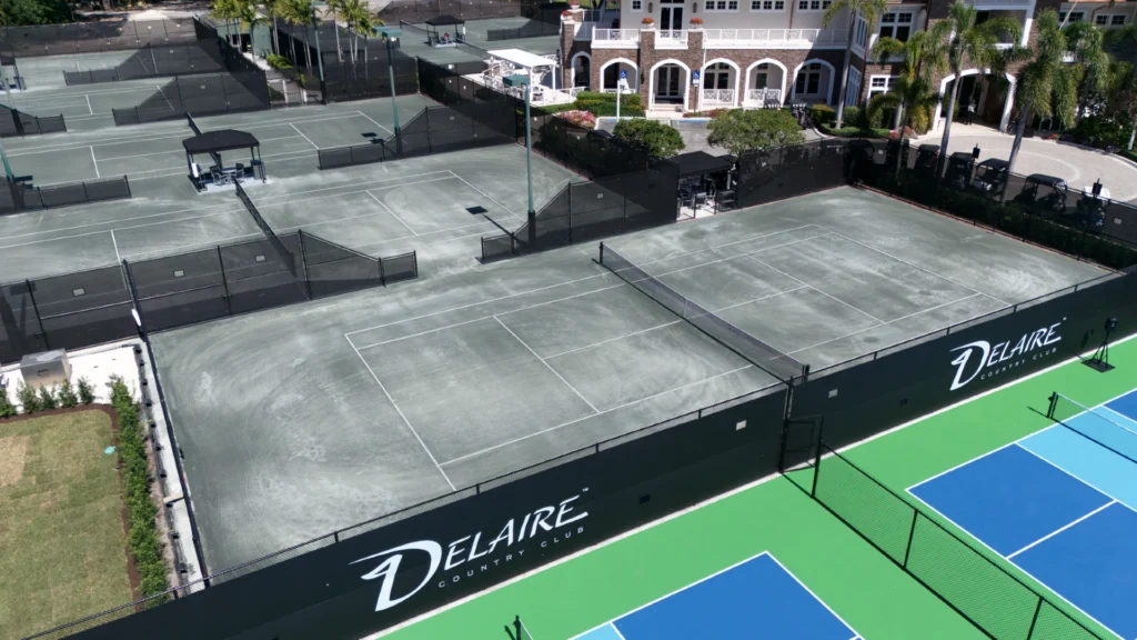 Aerial view of Delaire Country Club Har-Tru tennis and pickleball courts with clubhouse
