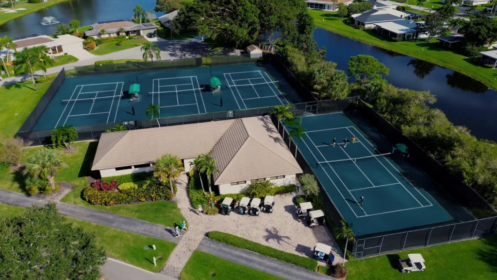 Aerial view of Eastpointe Country Club racquet center with tennis courts, pickleball courts and clubhouse in Palm Beach Gardens