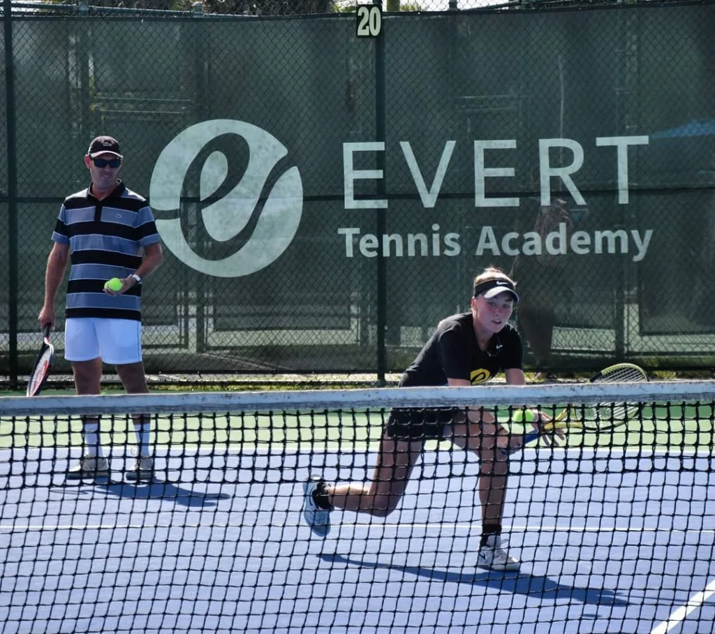 Junior tennis player participating in competitive training at Evert Tennis Academy