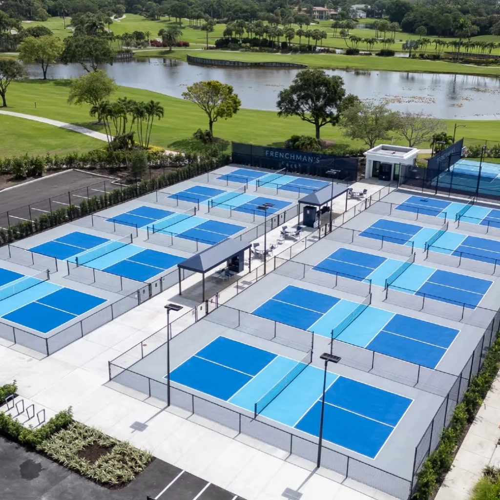Aerial view of Frenchman's Creek pickleball courts overlooking golf course and lake in Palm Beach Gardens Florida