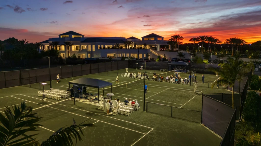 Evening tennis event on lighted courts at Frenchman's Creek Beach and Country Club at sunset in Palm Beach Gardens Florida