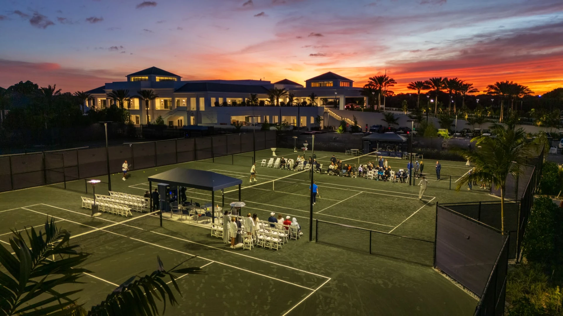 Evening tennis event on lighted courts at Frenchman's Creek Beach and Country Club at sunset in Palm Beach Gardens Florida