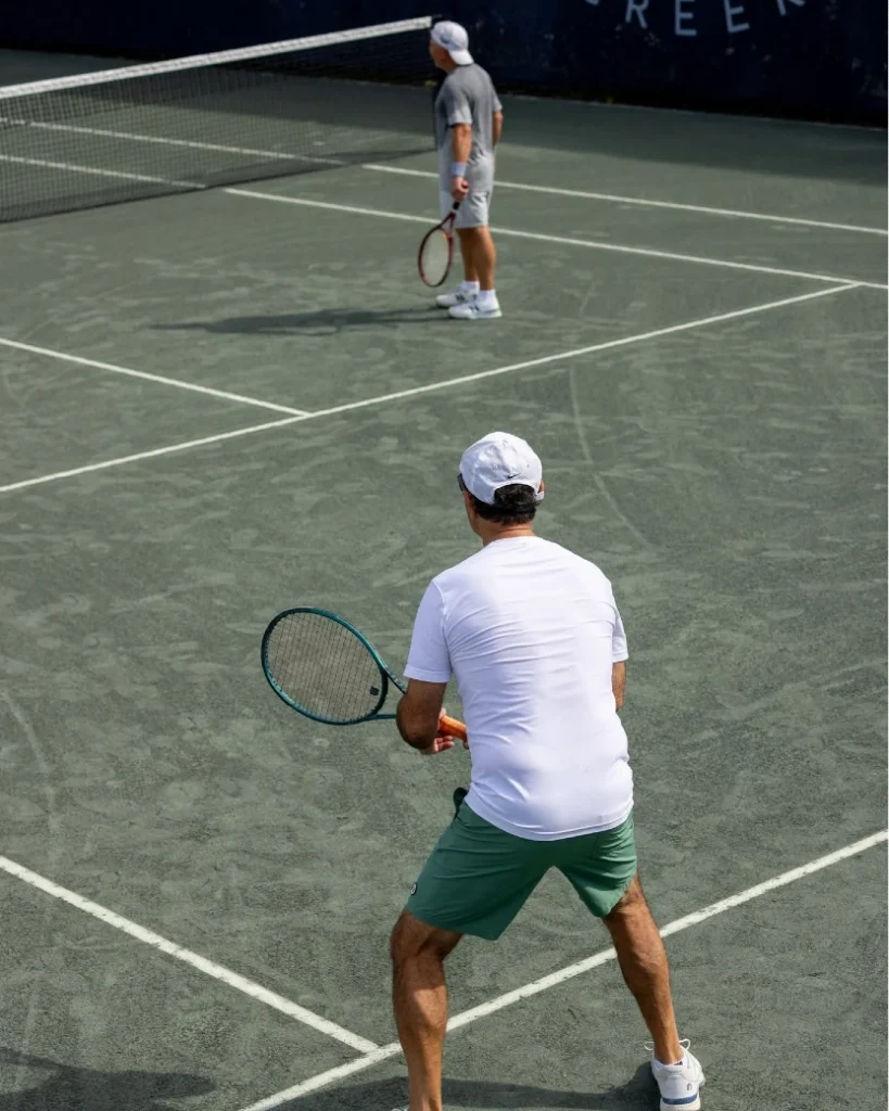 Two men playing doubles tennis at Frenchman's Creek Beach and Country Club in Palm Beach Gardens Florida