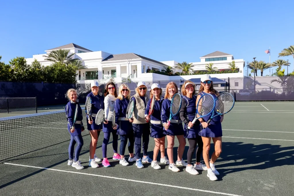 Women's tennis team posing on court at Frenchman's Creek Beach and Country Club in Palm Beach Gardens Florida
