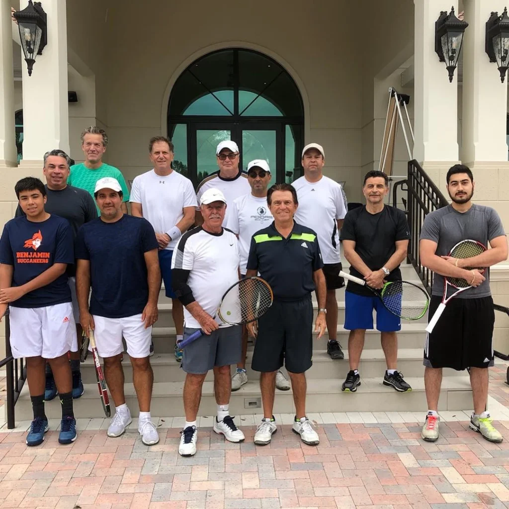 Men's tennis group with racquets on the clubhouse steps at Frenchman's Reserve