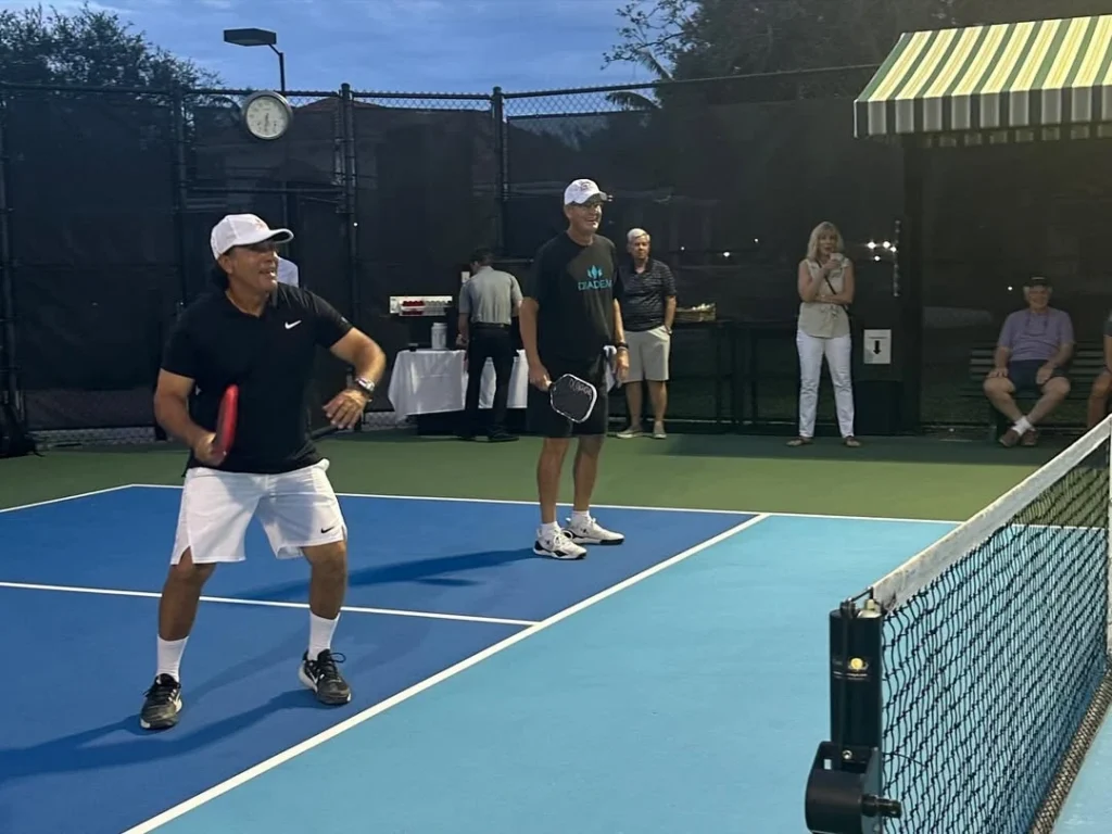 Doubles pickleball match under the lights at Frenchman's Reserve with spectators courtside