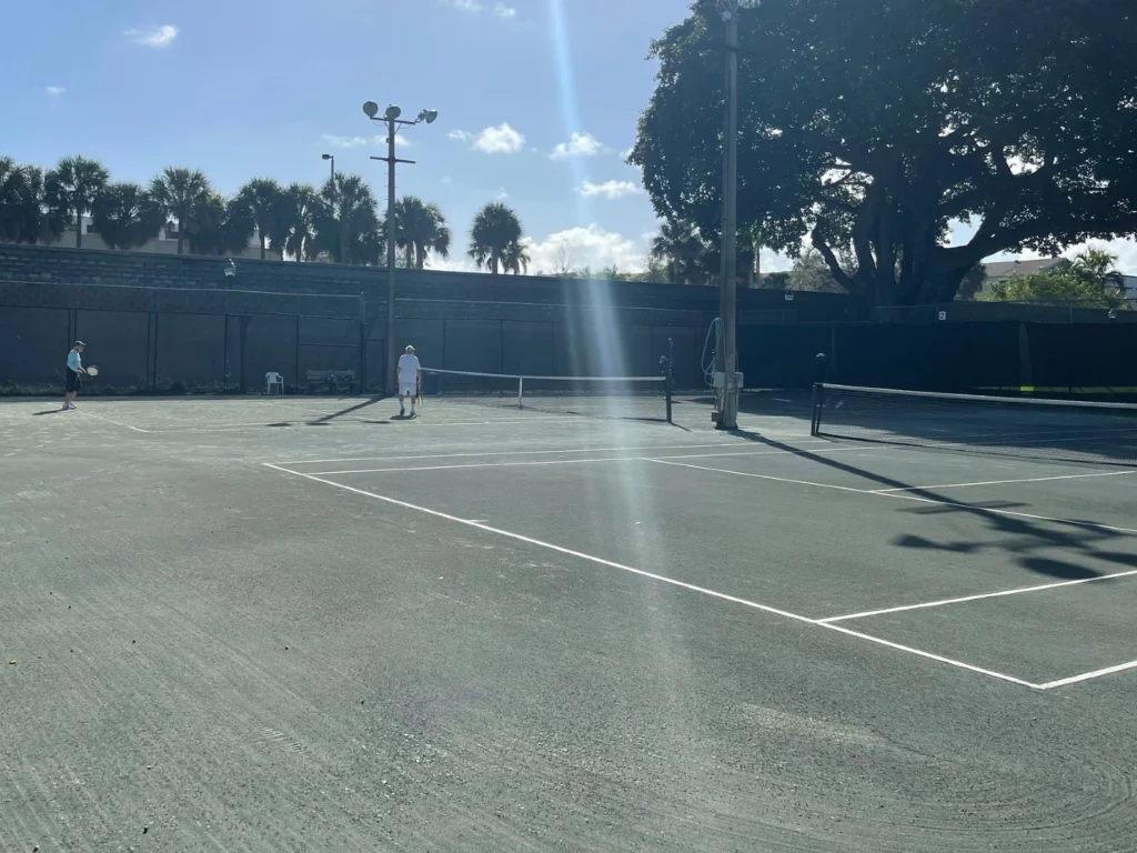 Players competing on Har-Tru clay courts at Howard Park Tennis & Pickleball Center in West Palm Beach