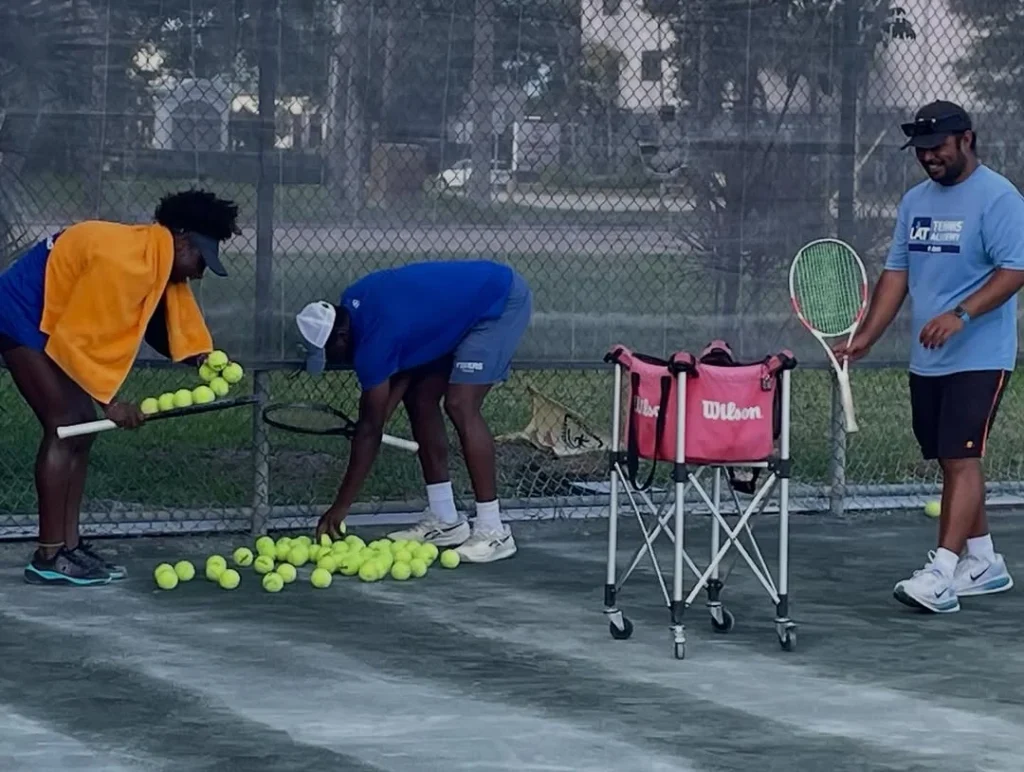 LAT Tennis Academy coaches conducting a junior tennis training session on Har-Tru courts