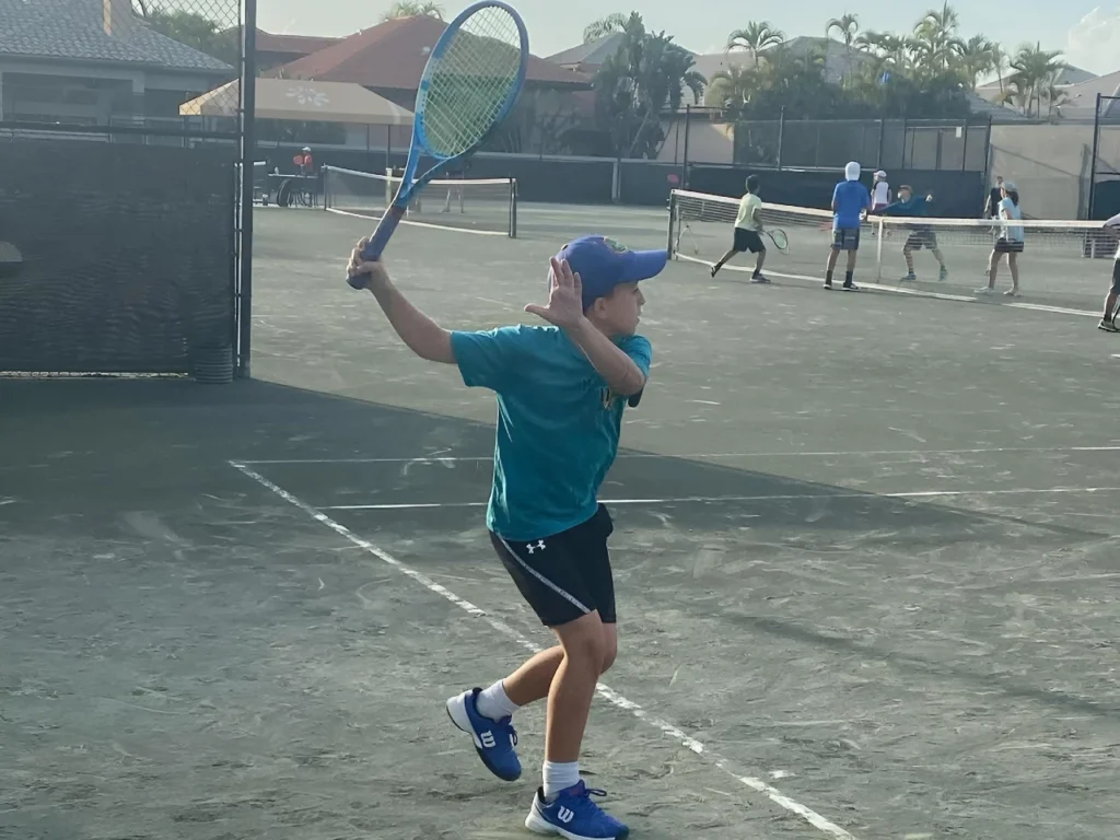 Junior player practicing on Har-Tru clay courts at Magallan Tennis Academy