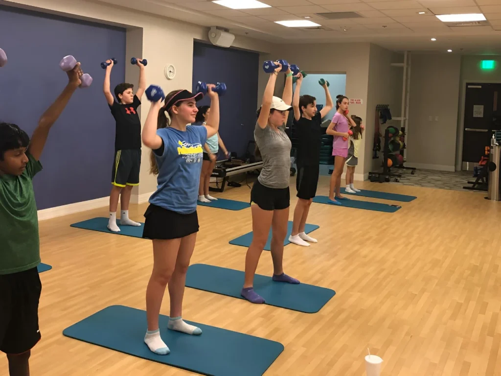 Junior tennis players participating in strength and conditioning training at Magallan Tennis Academy in Boca Raton
