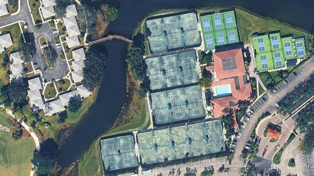 Aerial view of PGA National Sports and Racquet Club showing Har-Tru tennis courts and pickleball courts in Palm Beach Gardens Florida