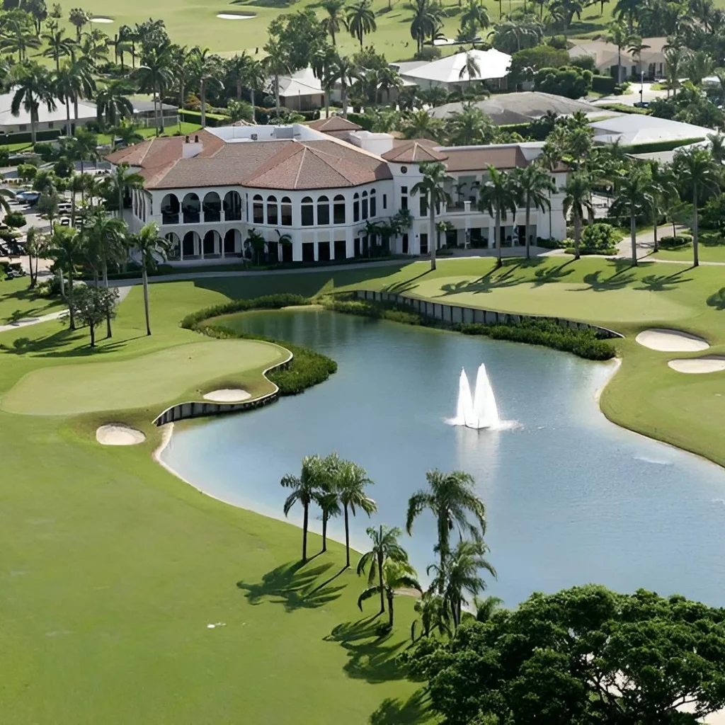 Aerial view of Royal Palm Yacht and Country Club golf course and clubhouse with lake and fountain in Boca Raton