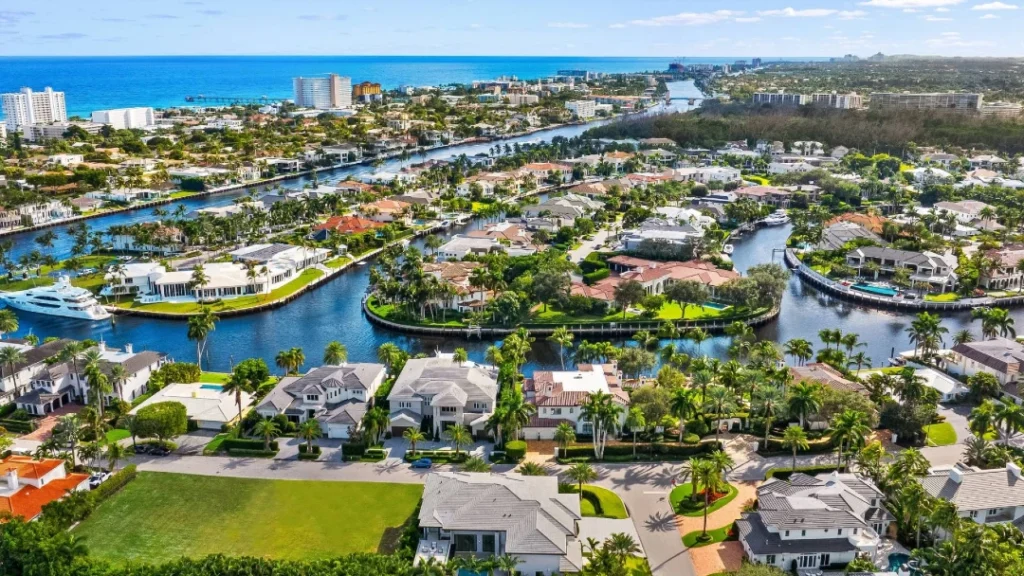 Aerial view of Royal Palm Yacht and Country Club waterfront estates along the Intracoastal Waterway with ocean views in Boca Raton