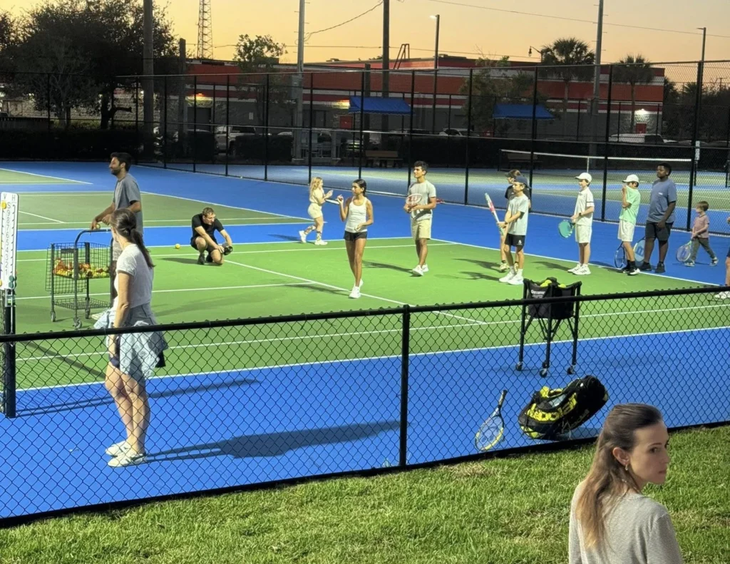 Junior tennis players participating in a South Olive Tennis Center program
