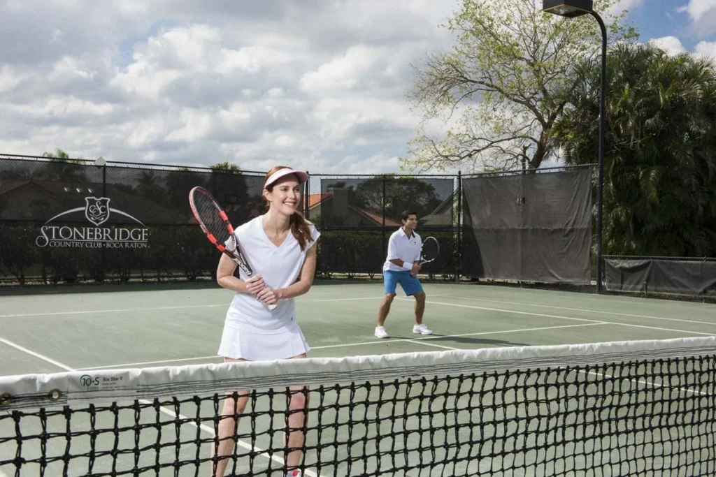 Members playing tennis on Har-Tru courts at Stonebridge Country Club in Boca Raton Florida