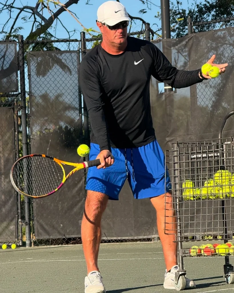 Tennis professional feeding balls during a clinic at The Bridges Racquet Center
