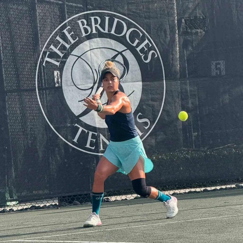 Player hitting on Har-Tru clay court at The Bridges Tennis in Delray Beach