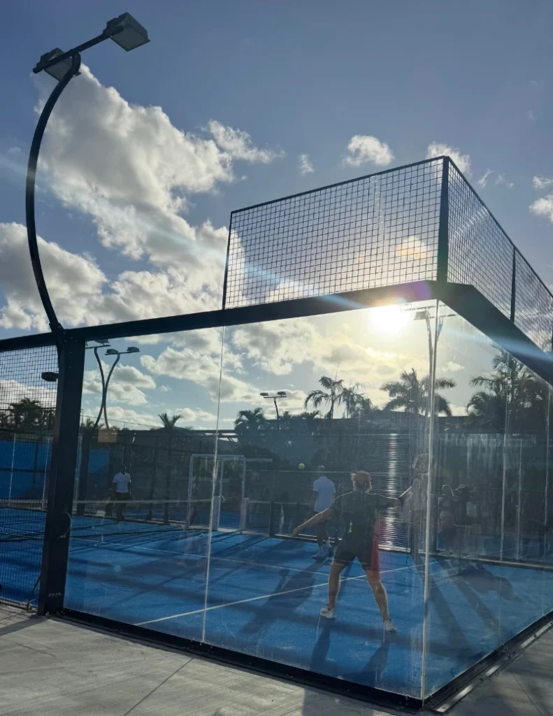 Players on glass-enclosed padel courts at The Club at Boca Pointe