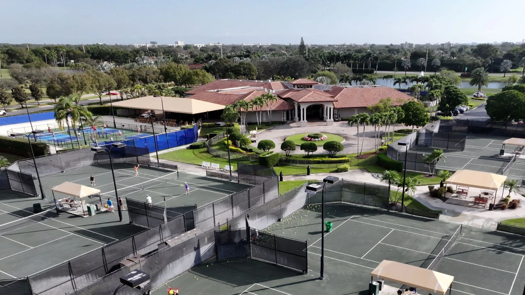 Aerial view of The Club at Boca Pointe racquet center with tennis courts, pickleball courts, clubhouse, and pool
