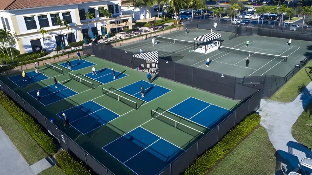 Aerial view of six active pickleball courts at The Club at Ibis Sports Village