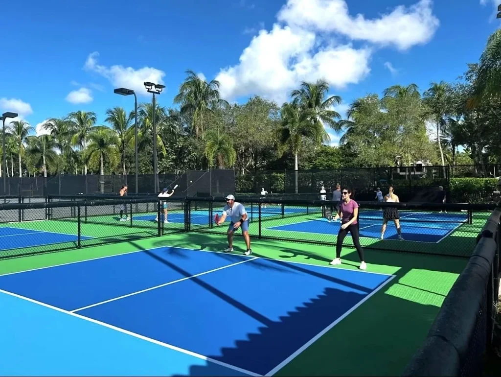 Players participating in pickleball at The Oaks Boca Raton dedicated pickleball courts