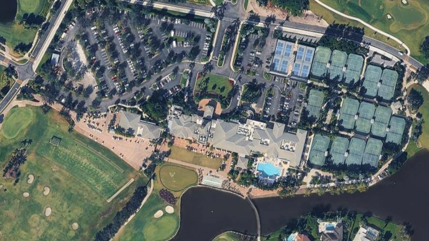 Aerial view of Wycliffe Golf & Country Club clubhouse, pool, tennis courts and pickleball courts in Wellington