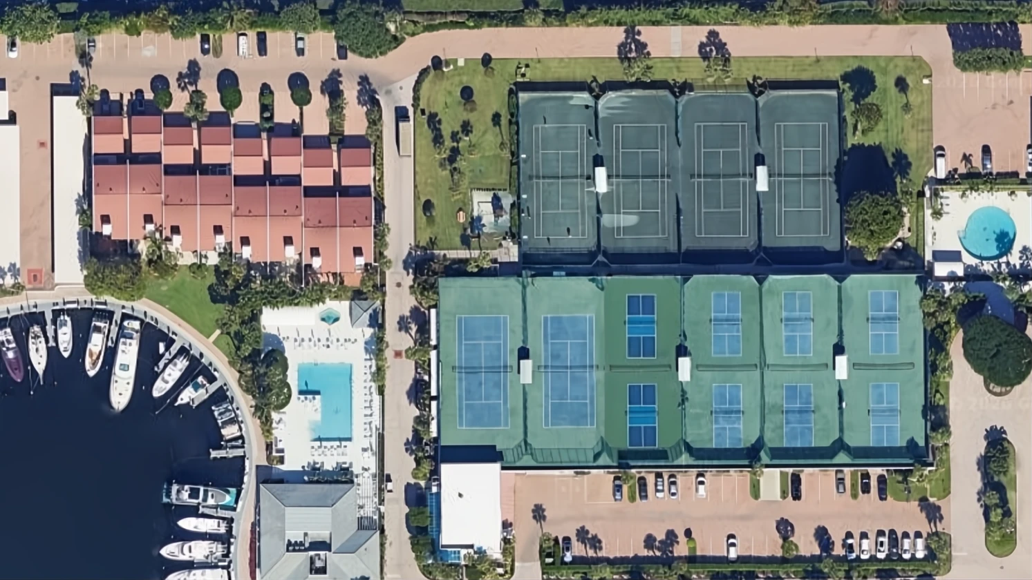 Aerial view of Yacht & Racquet Club of Boca Raton with marina, tennis facilities and Atlantic Ocean