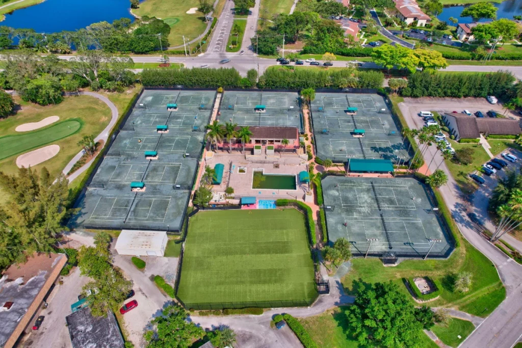 Aerial view of the Boca Lago Country Club racquet complex showing tennis courts, pickleball courts, clubhouse, and nearby residences.