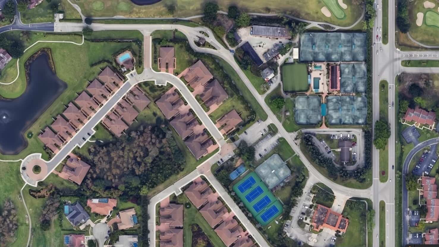 Aerial view of Boca Lago Country Club showing the clubhouse, tennis complex, golf course, and surrounding residential community in Boca Raton.