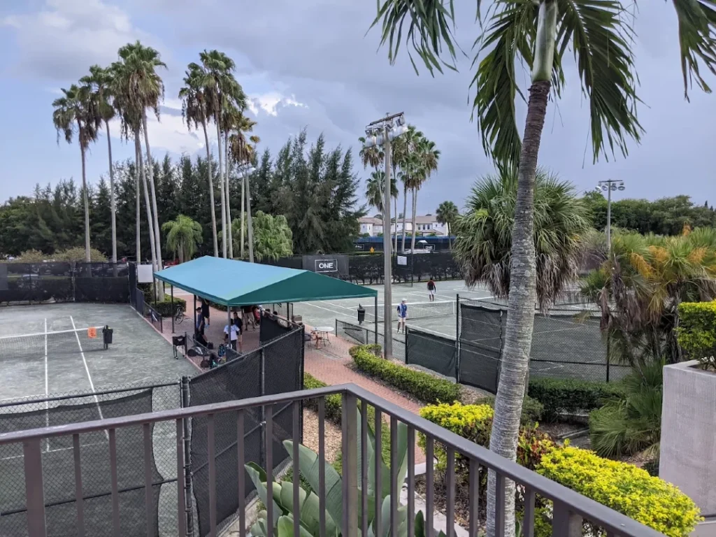 Players competing on the Har-Tru courts during a tennis event at Boca Lago Country Club.