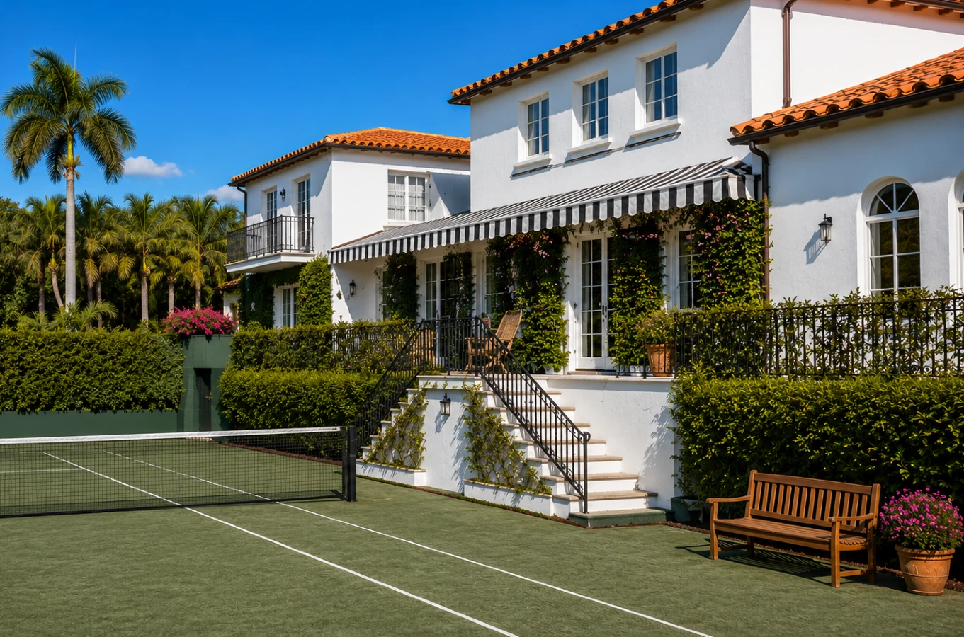 Luxury Palm Beach County home with a private Har-Tru tennis court and tropical landscaping