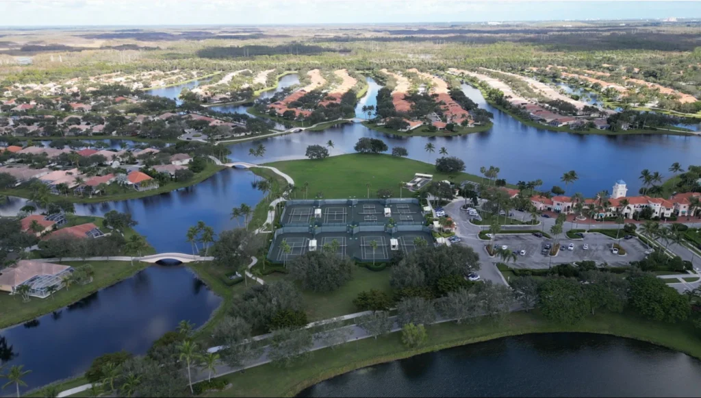 Aerial view of the RiverWalk clubhouse with Har-Tru tennis courts and pickleball courts in West Palm Beach